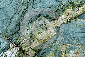 Background with green mineral rock close up, gemstone texture, olivine, amazonite, amphibolite