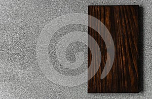 Background of grey stone texture and pattern with brown wooden cutting board.