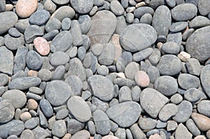 background of grey stones on the beach, large and small, pattern