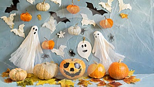 Background with halloween pumpkins, candles and autumn leaves on the wooden house porch