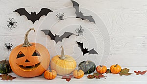 Background with halloween pumpkins, candles and autumn leaves on the wooden house porch