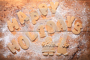 Background With Happy Holidays Written With Cookie Dough Letters and Powdered Sugar