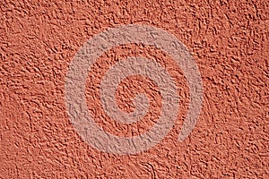 Background of harmonic bright red plaster wall with structure