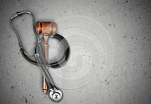 Wooden gavel and stethoscope, top view photo