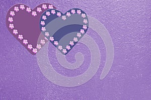 Background with hearts and flowers in purple and pink tones