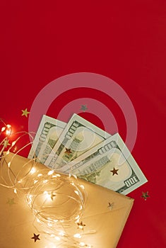 Background for holiday card with money US dollars. Background of one hundred dollar bills. Banknotes, paper currency on red