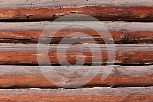 Background of horizontal hewed smooth painted wooden logs close up horizontal view