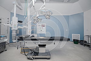 Empty operation room with surgery bed and surgery light photo