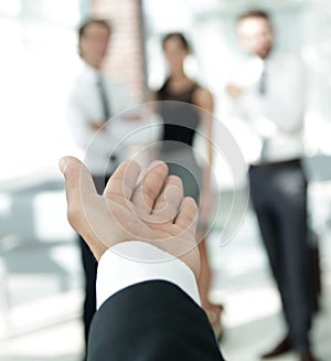 Background image of businessman holding out hand for a handshake.