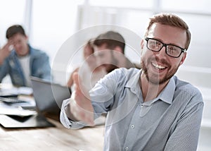 Background image of a businessman holding out his hand for a handshake