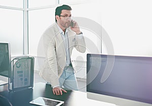 Background image of a businessman in a modern office.