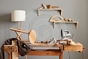Background image of carpenters workstation, carpenters work table with different tools, wood cutting, a jigsaw, a cipher machine,