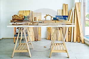 Background image of carpenters workstation, carpenters work table with different tools and wood cutting stand with wood shavings