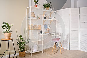 Background image of empty home office working space in a cozy apartment with modern scandinavian design. White table chair