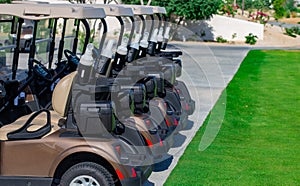 Background image of Golf carts parked on a golf closure in a line