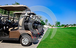 Background image of Golf carts parked on a golf closure in a line