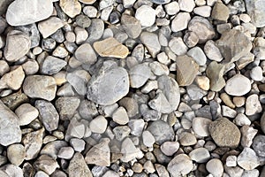 Background image with grey and beige stones and pebbles on the floor