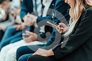 background image of a group of young people sitting in a queue