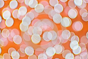 Background image with orange and white bokeh lights.