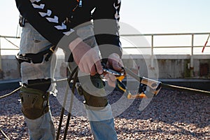 Background image of the process of work on a high-rise building. unset light on metal climbing gear photo