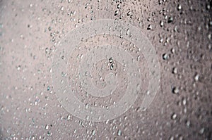 Background image of rain drops on a glass window. Macro photo with shallow depth of fiel