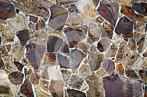 Background image of a stone fence of multi-colored stones