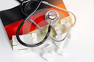 Background image of sugar cubes with medical stethoscope and healthcare in Germany