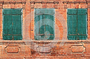 Background image of three old green bolted shuttered windows