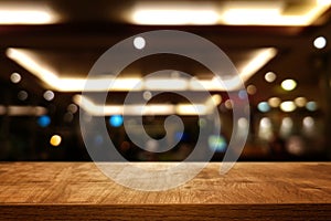 background Image of wooden table in front of abstract blurred restaurant lights