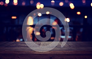 Background Image of wooden table in front of abstract blurred restaurant lights