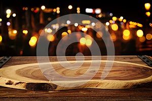Background Image of wooden table in front of abstract blurred restaurant lights