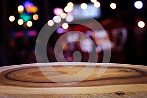 Background Image of wooden table in front of abstract blurred restaurant lights