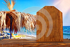 background Image of wooden table in front of tropical beach. Ready for product display. Menu backdrop