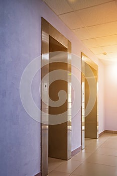 Background of interior floor of elevator platform with elevators and sunlight in business center
