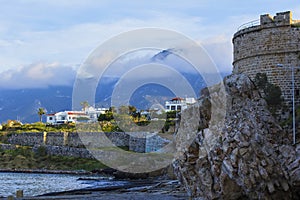Background landscape view of the quay of Kyrenia and the tower of the Kirinis fortress on the north