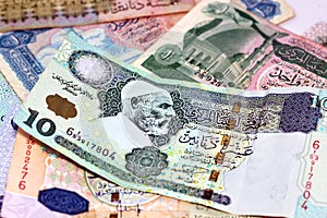 Background of Libyan money dinars banknotes with portraits of Omar Al-Mukhtar and Muammar Gaddafi on some banknotes