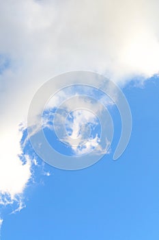 Background with light blue sky and softy white cloud, vertical