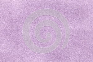 Background of light violet suede fabric closeup. Velvet matt texture of lilac nubuck textile