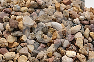 Background of little dark, brown, red and yellow stones close up view