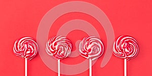 Background of lollipops of red color with white. photo