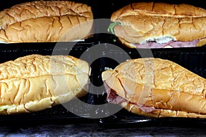 Background of long bun bread filled with Salami, smoked Turkey chicken beast meat, roast beef slices mixed with lettuce,