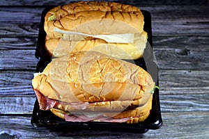 Background of long bun bread filled with Salami, smoked Turkey chicken beast meat, roast beef slices mixed with lettuce,