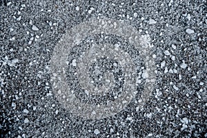 Background- looking down at rock salt sprinkled on snow on backtop surface -grainy