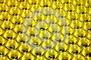 A background of lots of glossy yellow bubbles.