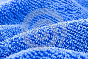 Background made of blue microfiber fabric, selective focus.
