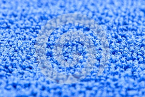 Background made of blue microfiber fabric, selective focus.