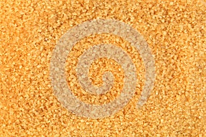Background made of brown sugar. Crystallized sweetener