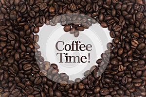 Background made of coffee beans in a heart shape with message `Coffee Time!`