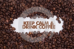 Background made of coffee beans with message `Keep Calm & Drink Coffee`