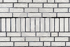 Background made of the facade of the building made white brick, a large fugue between the bricks is visible.